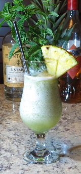 Missionary's Downfall Cocktail with pineapple segment and mint sprig garnish