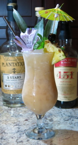 A Piña Colada cocktail with a mint and pineapple wedge garnish