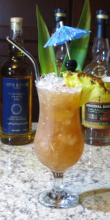 Planter's Punch cocktail with a pineapple and umbrella garnish