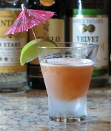 Port Au Prince Cocktail with a lime segment and umbrella garnish