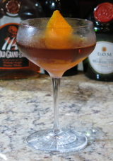 Preakness cocktail with an orange twist garnish